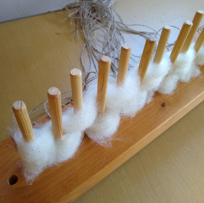 Weaving the seat pads on a peg loom