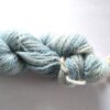 hank of blue sock yarn on a graded white to grey background