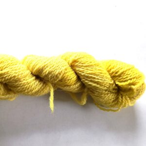 hank of bright yellow sock yarn on a graded white to grey background