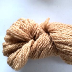 hank of brown sock yarn on a graded white to grey background