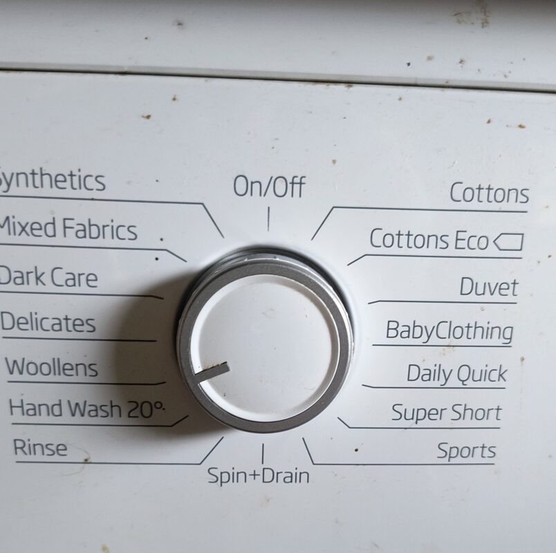the washing options on a washing machine with the dial turned to woollens