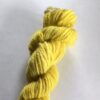 Bright yellow skein of wool yarn on a white background