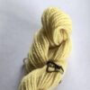 Pale yellow wool yarn skein on a white background