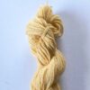 An apricot skein of wool yarn on a white background