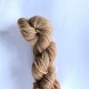 Skein of fawn yarn on a white background