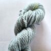 Pale sky blue skein of wool yarn on a white background