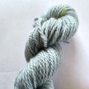 Pale sky blue skein of wool yarn on a white background